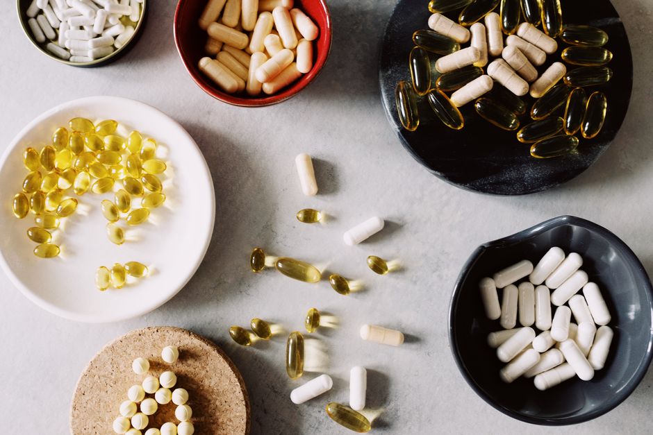 Ashwagandha and turmeric supplements next to oxycodone pills representing potential drug interactions