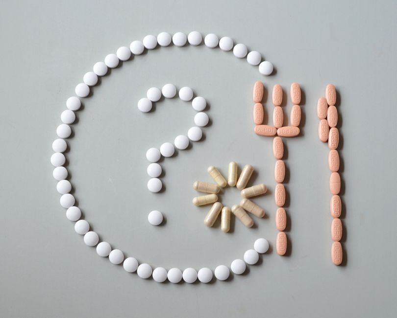 Assortment of foods and hydrocodone pills illustrating food interactions to avoid while taking hydrocodone