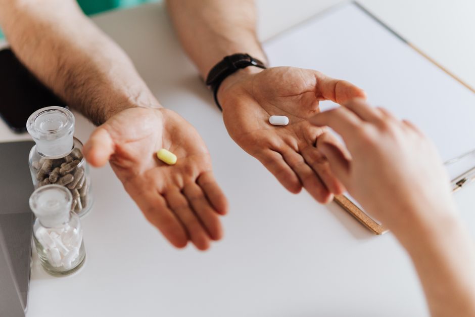 Bottles of oxycodone and Dilaudid pills side by side representing an opioid medication comparison
