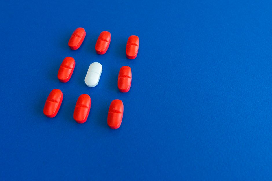 Bottles of oxycodone and morphine pills side by side representing an opioid strength comparison
