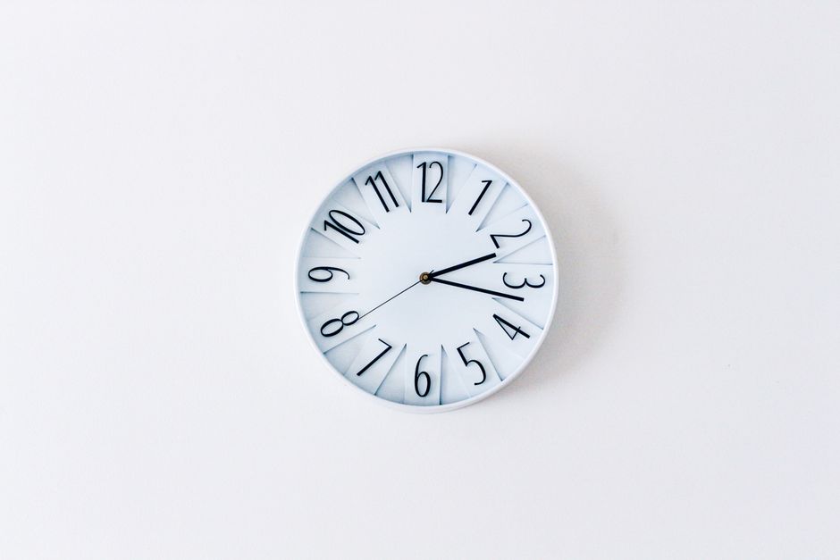 Clock and pill bottle representing how long oxycodone stays in the system based on its half-life