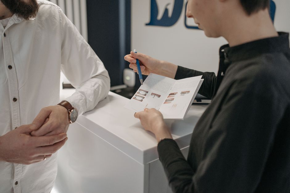 Doctor discussing why oxycodone is not working anymore with a patient holding a prescription bottle