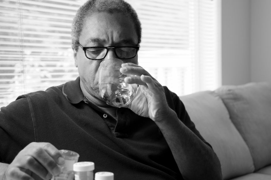 Glass of water with Miralax powder being mixed for opioid-induced constipation relief