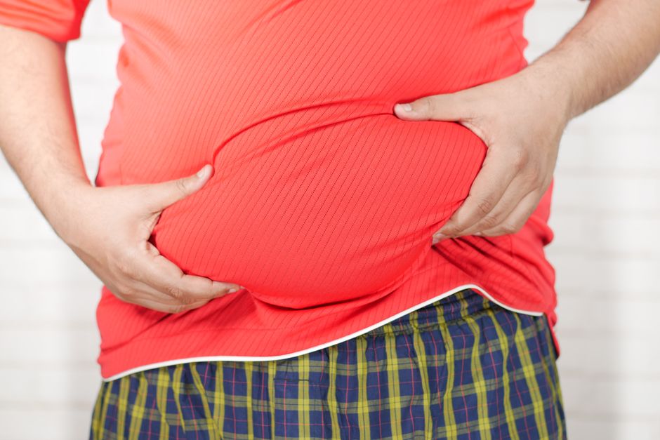 Person holding stomach in discomfort due to hydrocodone-induced constipation