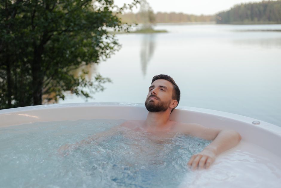 Person relaxing in a steaming hot tub, illustrating safety concerns about using a hot tub after taking oxycodone