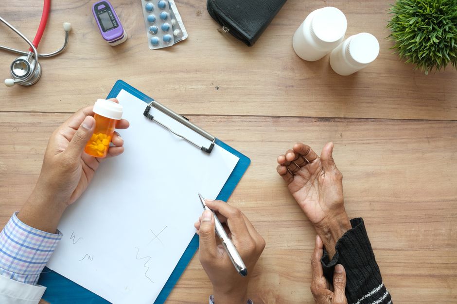 Person reviewing an oxycodone safety checklist next to a prescription pill bottle