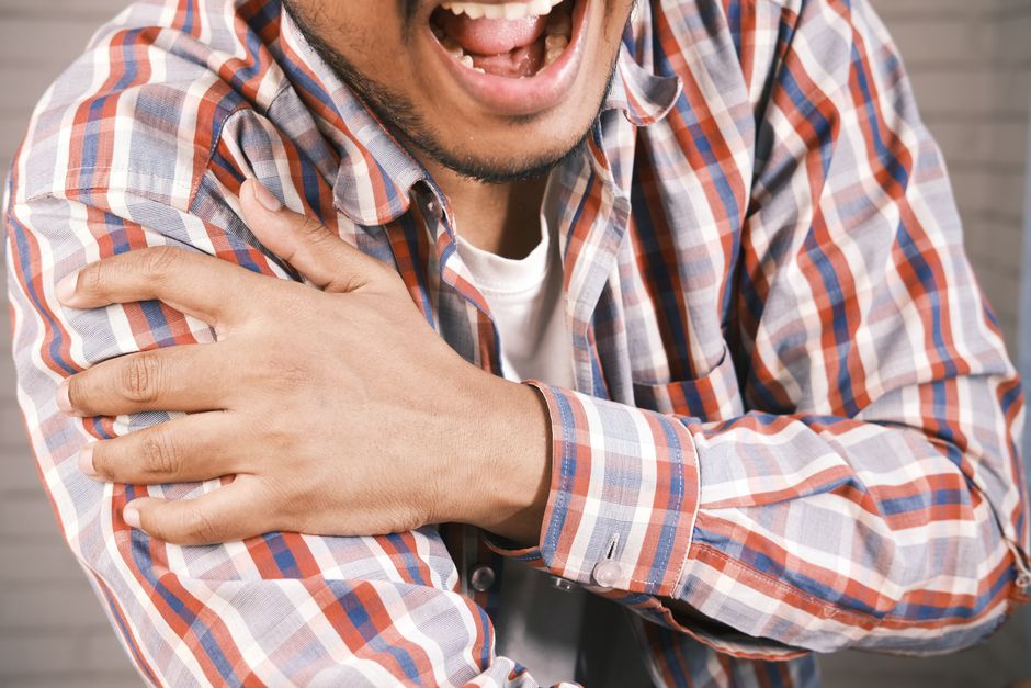 Person scratching their itchy arm due to oxycodone side effects