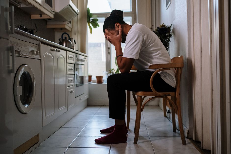 Person sitting on a bed looking exhausted during oxycodone withdrawal recovery