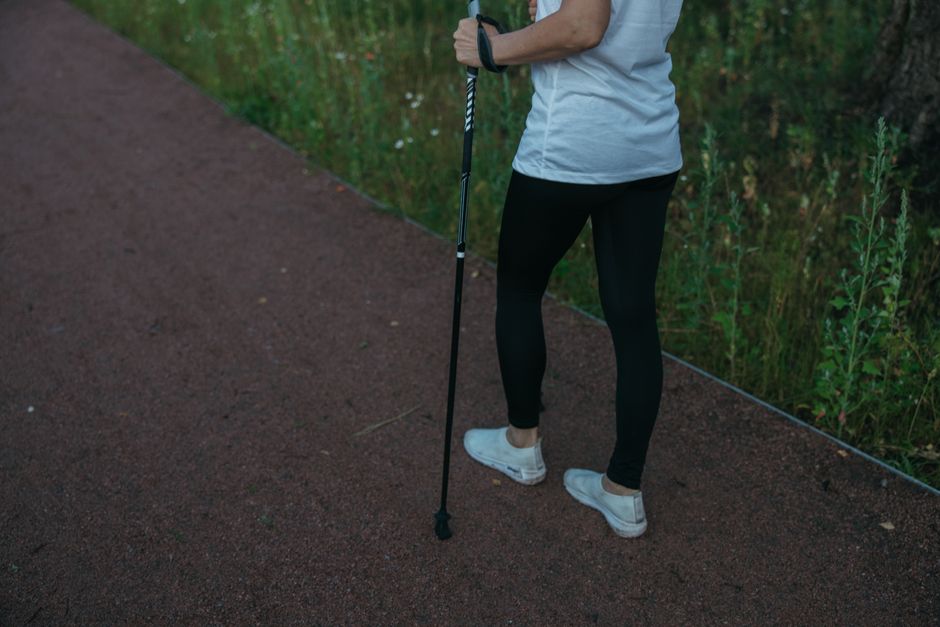 Person taking a slow walk outdoors while managing pain medication recovery