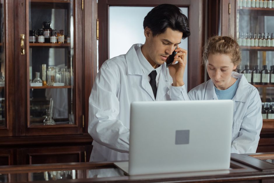 Pharmacist discussing prescription medication safety questions with a patient