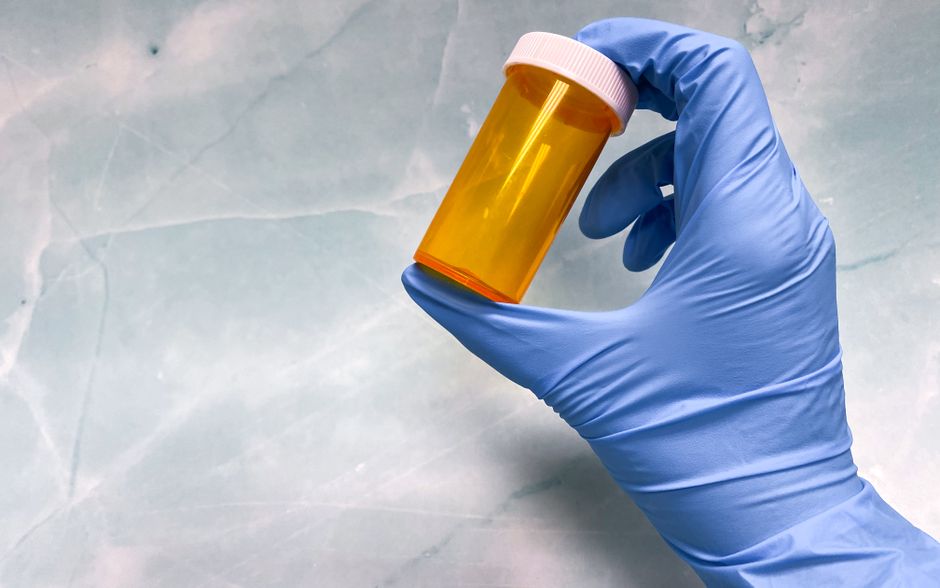 Pharmacist reviewing an oxycodone prescription bottle in a Pennsylvania pharmacy