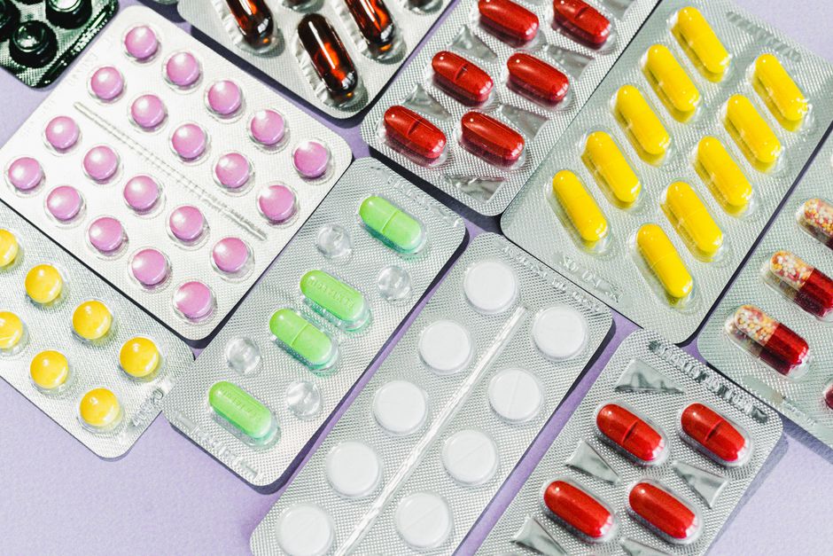 Traveler placing prescription medication bottle into carry-on bag before airport security screening