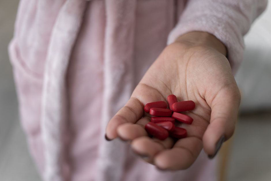 Woman experiencing nausea after taking oxycodone medication